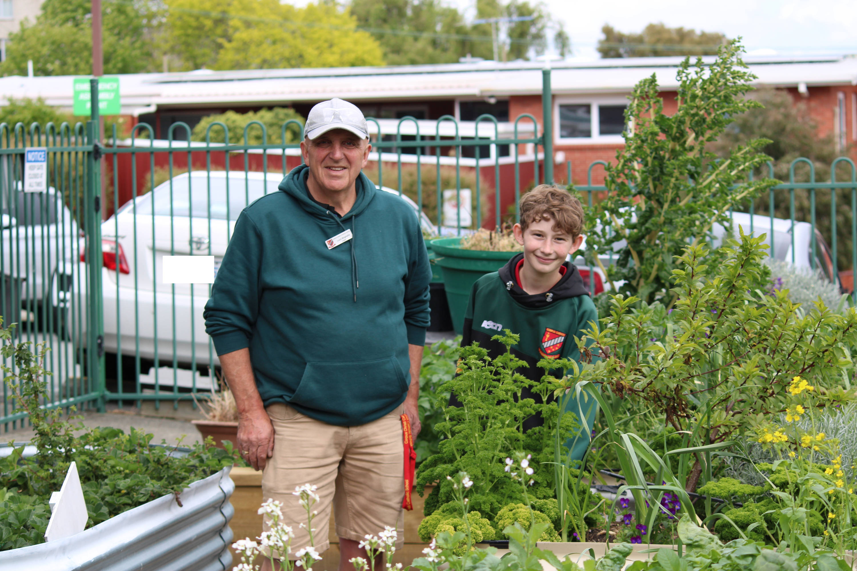 Teacher Luch Brighella and Matthew Jones in the Corpus Christi Catholic School garden.